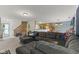 Spacious living room with a large sectional sofa, open floor plan, and staircase access at 11532 Glenn Abbey Ln, Indianapolis, IN 46235