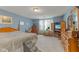 Spacious main bedroom with a large bed, wooden furniture, and neutral carpet at 11532 Glenn Abbey Ln, Indianapolis, IN 46235