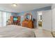 Bright main bedroom features a TV, dresser, and access to an ensuite bathroom at 11532 Glenn Abbey Ln, Indianapolis, IN 46235