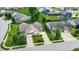 An aerial view showcasing a neighborhood and surrounding lawns and mature trees at 1163 Meadowlark Dr, Greenwood, IN 46143