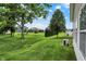 Grassy backyard with mature trees and view of surrounding homes in the neighborhood at 1163 Meadowlark Dr, Greenwood, IN 46143