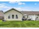 Home's back exterior features manicured lawn, multiple windows, and vinyl siding at 1163 Meadowlark Dr, Greenwood, IN 46143