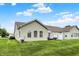 Home's back exterior features manicured lawn, multiple windows, and vinyl siding at 1163 Meadowlark Dr, Greenwood, IN 46143