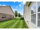 A sprawling green backyard between two houses beneath a blue sky with wispy clouds at 1163 Meadowlark Dr, Greenwood, IN 46143