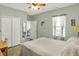 Bedroom features wood floors, a ceiling fan, and access to the ensuite bath at 1163 Meadowlark Dr, Greenwood, IN 46143