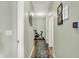 Hallway with hardwood floors, light green walls, decor, and an exercise bike at 1163 Meadowlark Dr, Greenwood, IN 46143