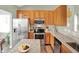 Open kitchen featuring wooden cabinetry, stainless steel appliances, and a functional island with granite countertops at 1163 Meadowlark Dr, Greenwood, IN 46143