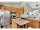 Open kitchen featuring wooden cabinetry, stainless steel appliances, and a functional island with granite countertops at 1163 Meadowlark Dr, Greenwood, IN 46143