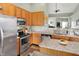 Open kitchen featuring wooden cabinetry, stainless steel appliances, and a functional island with granite countertops at 1163 Meadowlark Dr, Greenwood, IN 46143