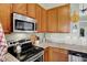 Kitchen showcasing modern stainless steel appliances, granite countertops, and custom cabinetry at 1163 Meadowlark Dr, Greenwood, IN 46143