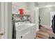 Functional laundry room with a washer, dryer, shelving, and exercise bike at 1163 Meadowlark Dr, Greenwood, IN 46143