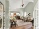 Open living room featuring vaulted ceilings, hardwood floors, and comfortable seating arrangement at 1163 Meadowlark Dr, Greenwood, IN 46143