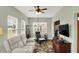 Comfortable living room with a ceiling fan, large windows, and a television on top of a wooden media center at 1163 Meadowlark Dr, Greenwood, IN 46143