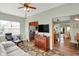 Living room features an elegant cabinet, lots of natural light, and a cozy sectional at 1163 Meadowlark Dr, Greenwood, IN 46143