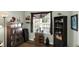 Home office featuring a large window, bookshelves, and a wooden cabinet at 1163 Meadowlark Dr, Greenwood, IN 46143