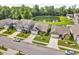 Aesthetic aerial view of a residential street with tree-lined yards and a community pond at 1181 S Aberdeen Dr, Franklin, IN 46131
