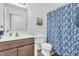 Bathroom with a dark wood vanity and blue patterned shower curtain, with wood-look floors at 1181 S Aberdeen Dr, Franklin, IN 46131