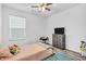 Cozy bedroom with a ceiling fan, grey dresser, and natural light from the window at 1181 S Aberdeen Dr, Franklin, IN 46131