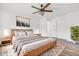 Bright primary bedroom boasts a ceiling fan, modern furnishings, and neutral color palette at 1181 S Aberdeen Dr, Franklin, IN 46131
