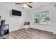 Cozy bedroom with wood flooring, a ceiling fan, a window, and a television mounted on the wall at 1181 S Aberdeen Dr, Franklin, IN 46131