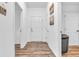 Hallway with white walls, wood-look flooring, and doors with views to other rooms at 1181 S Aberdeen Dr, Franklin, IN 46131