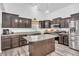 Spacious kitchen with stainless steel appliances, granite countertops, island and dark wood cabinets at 1181 S Aberdeen Dr, Franklin, IN 46131