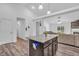 Open-concept kitchen with dark cabinets, stainless steel appliances, and a central island at 1181 S Aberdeen Dr, Franklin, IN 46131