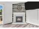 Close up of fireplace with wooden mantle and wooden accent wall in the living room at 1181 S Aberdeen Dr, Franklin, IN 46131