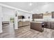 Open-concept living room and kitchen area with hardwood floors and a cozy fireplace at 1181 S Aberdeen Dr, Franklin, IN 46131