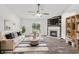 Bright living room features a fireplace, modern furnishings, and a view of the backyard at 1181 S Aberdeen Dr, Franklin, IN 46131