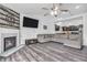 Open concept living room featuring a fireplace and view into the kitchen with dark cabinets at 1181 S Aberdeen Dr, Franklin, IN 46131