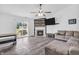 Open concept living room featuring a fireplace, sliding glass doors to the backyard, and ceiling fan at 1181 S Aberdeen Dr, Franklin, IN 46131