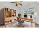 Bright office space with wood floors, a bookshelf, a desk, and large window overlooking the yard at 1181 S Aberdeen Dr, Franklin, IN 46131