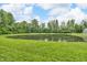 Scenic view of a tranquil pond surrounded by lush greenery, creating a peaceful and natural setting at 1181 S Aberdeen Dr, Franklin, IN 46131