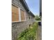 Exterior of a home with a boarded-up window and stone siding at 1214 Wallace Ave, Indianapolis, IN 46201