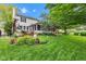 Landscaped backyard featuring a multi-level deck, screened in porch, and large lawn at 12234 Limestone Dr, Fishers, IN 46037