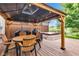 Backyard deck featuring wood furniture, a gazebo, grill, and hot tub at 12234 Limestone Dr, Fishers, IN 46037