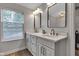Bright bathroom featuring double sinks, modern fixtures, and large mirrors at 12234 Limestone Dr, Fishers, IN 46037