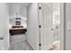 Hallway view to a bedroom with a ceiling fan and an en suite bathroom at 12234 Limestone Dr, Fishers, IN 46037
