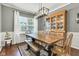 Formal dining area with a large window, a modern chandelier, and an antique china cabinet at 12234 Limestone Dr, Fishers, IN 46037