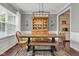 Elegant dining room with a wooden table, stylish chandelier, and a built-in china cabinet at 12234 Limestone Dr, Fishers, IN 46037