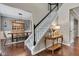 Open foyer showcases a staircase with wood floors, and views of the dining area with a large table at 12234 Limestone Dr, Fishers, IN 46037