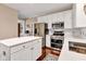 Modern kitchen with stainless steel appliances and white cabinets offers plenty of storage at 12234 Limestone Dr, Fishers, IN 46037