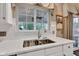 Kitchen features a stainless steel sink, gooseneck faucet and bright window at 12234 Limestone Dr, Fishers, IN 46037