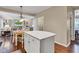 Bright eat-in kitchen with white island and breakfast table flows into the living room at 12234 Limestone Dr, Fishers, IN 46037