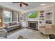 Bright living room with fireplace, built-ins, and large windows at 12234 Limestone Dr, Fishers, IN 46037