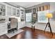 Bright home office with built-in shelving, hardwood floors, and windows that offer plenty of natural light at 12234 Limestone Dr, Fishers, IN 46037
