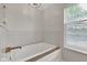 Close up of white soaking tub with bronze water fixtures at 12234 Limestone Dr, Fishers, IN 46037
