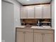 Basement wet bar area with countertop, cabinets, and shelving at 12234 Limestone Dr, Fishers, IN 46037