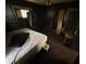 Image shows a bedroom with bed, mattress and a dark floor with peeling paint at 1226 Hiatt St, Indianapolis, IN 46221